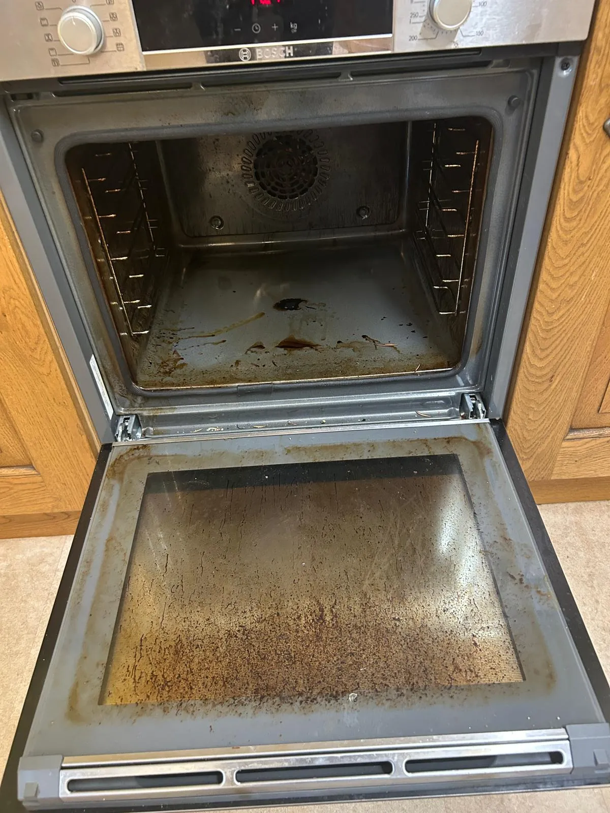 Greasy oven interior before professional cleaning